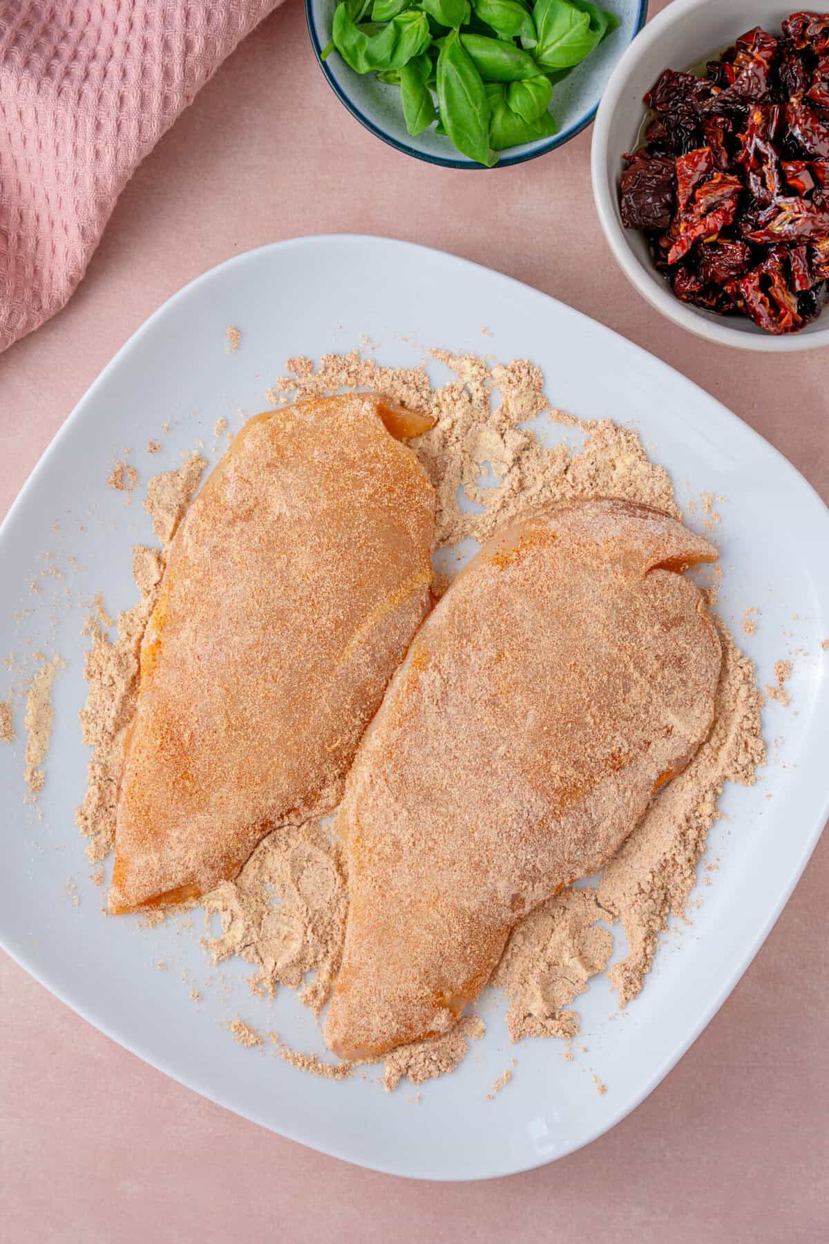 Coat the chicken breasts in the flour and paprika.