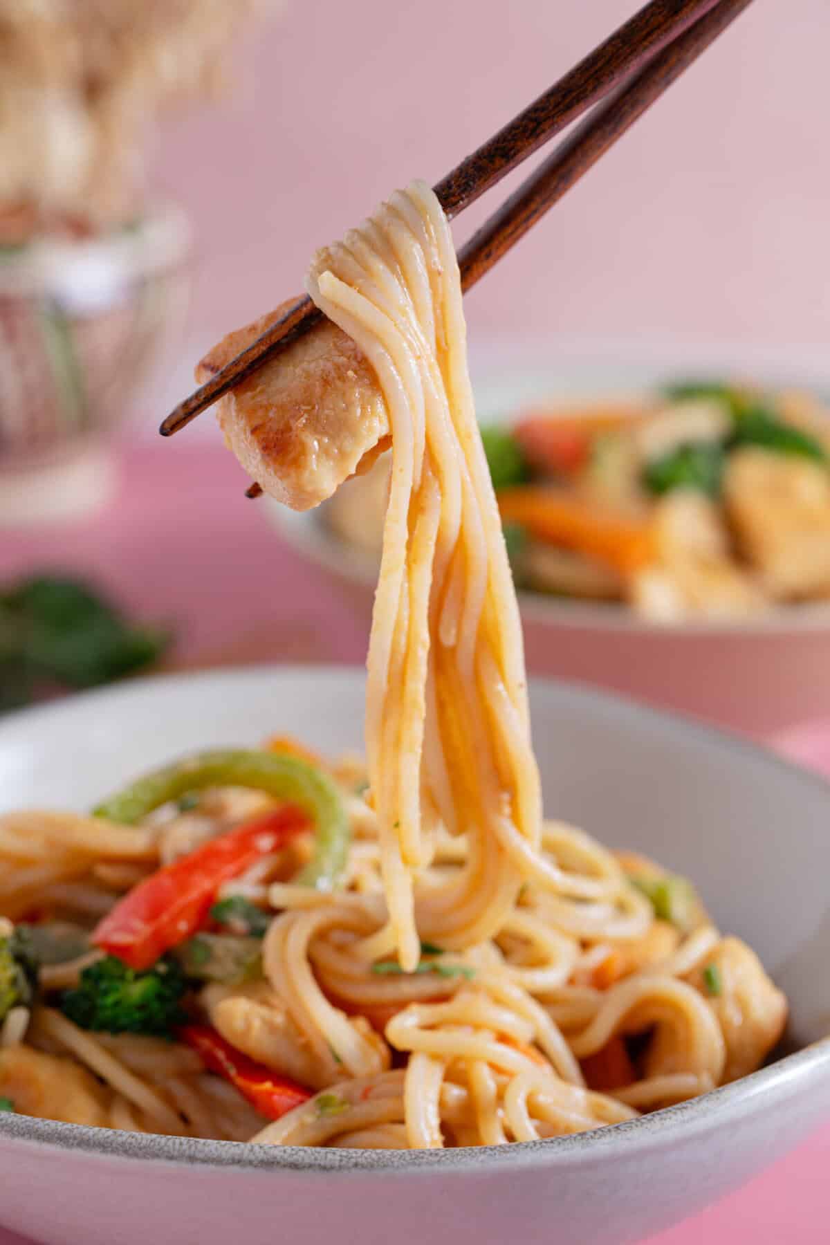 Chopsticks with peanut butter noodles.
