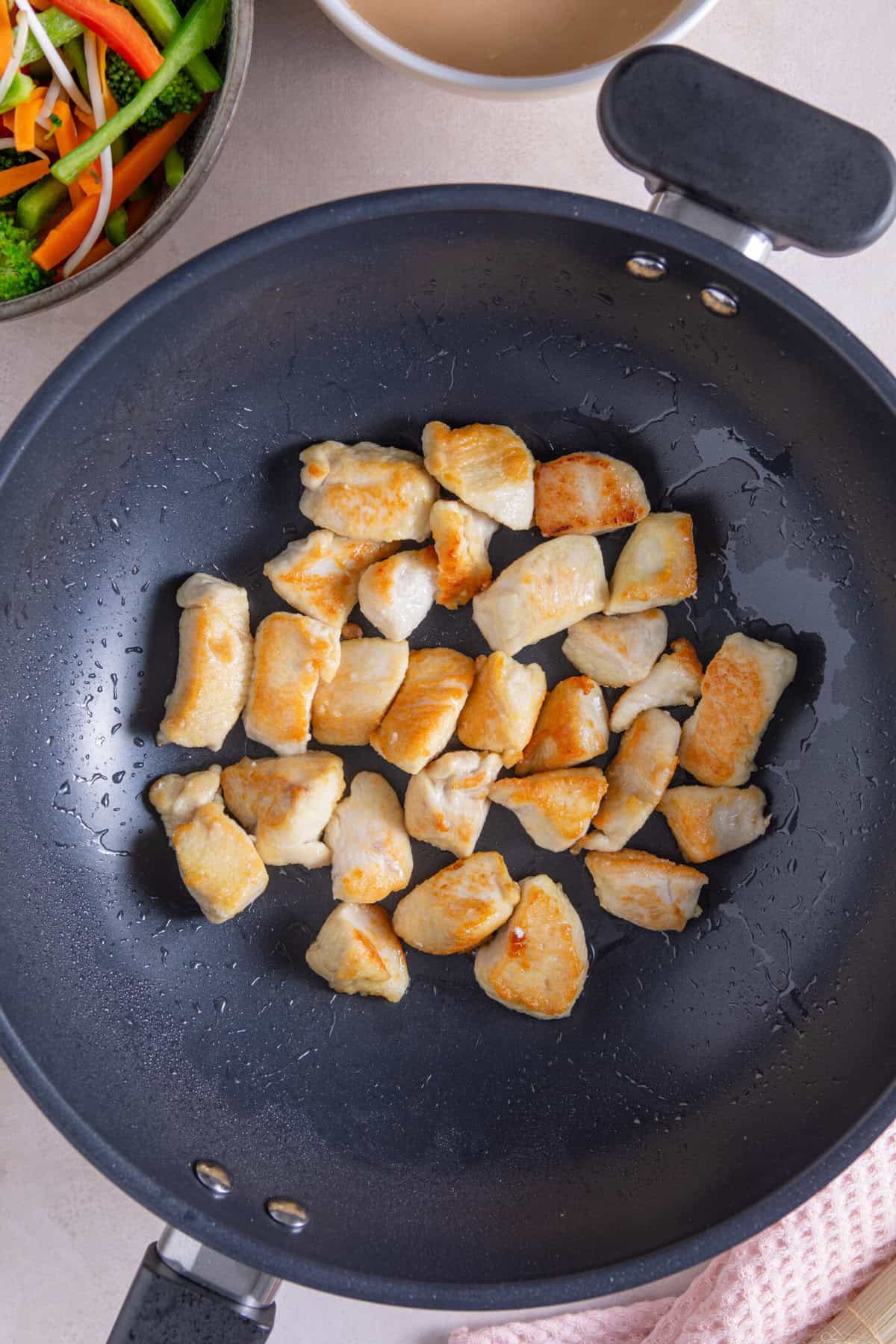 Fry the chicken in the coconut oil until browned.