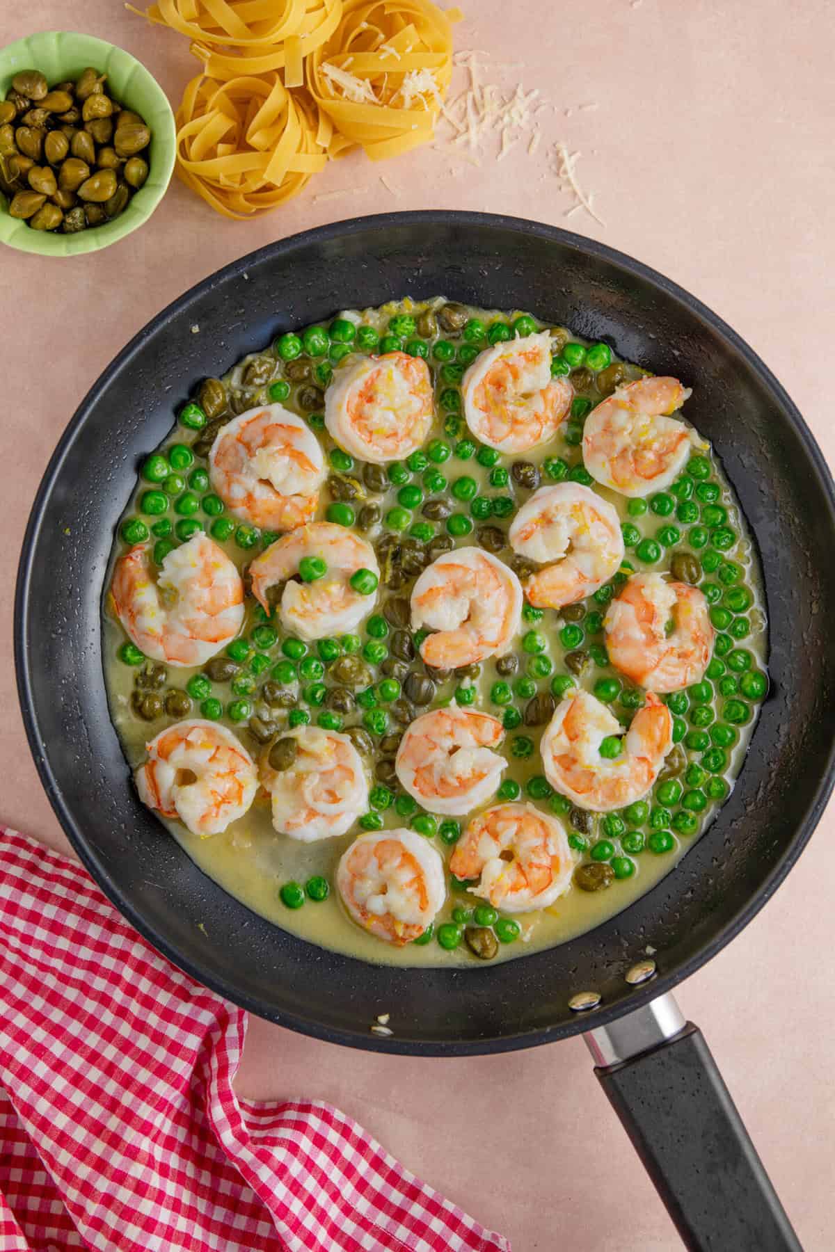 Add the white wine and peas to the pan.