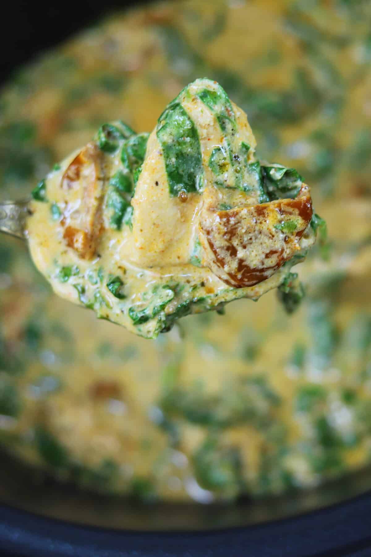 A spoonful of slow cooker Tuscan chicken.