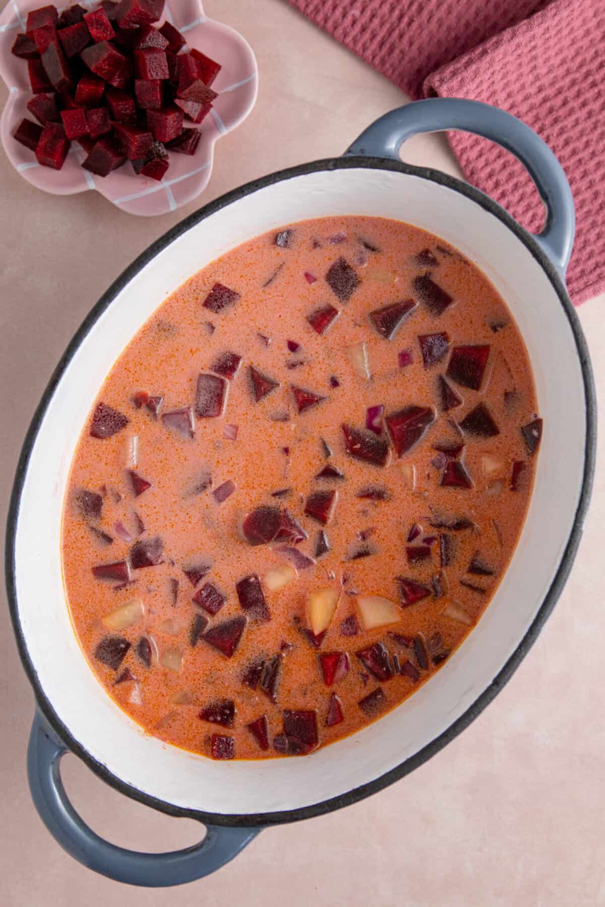 Pour the vegetable stock and coconut milk into the pan.