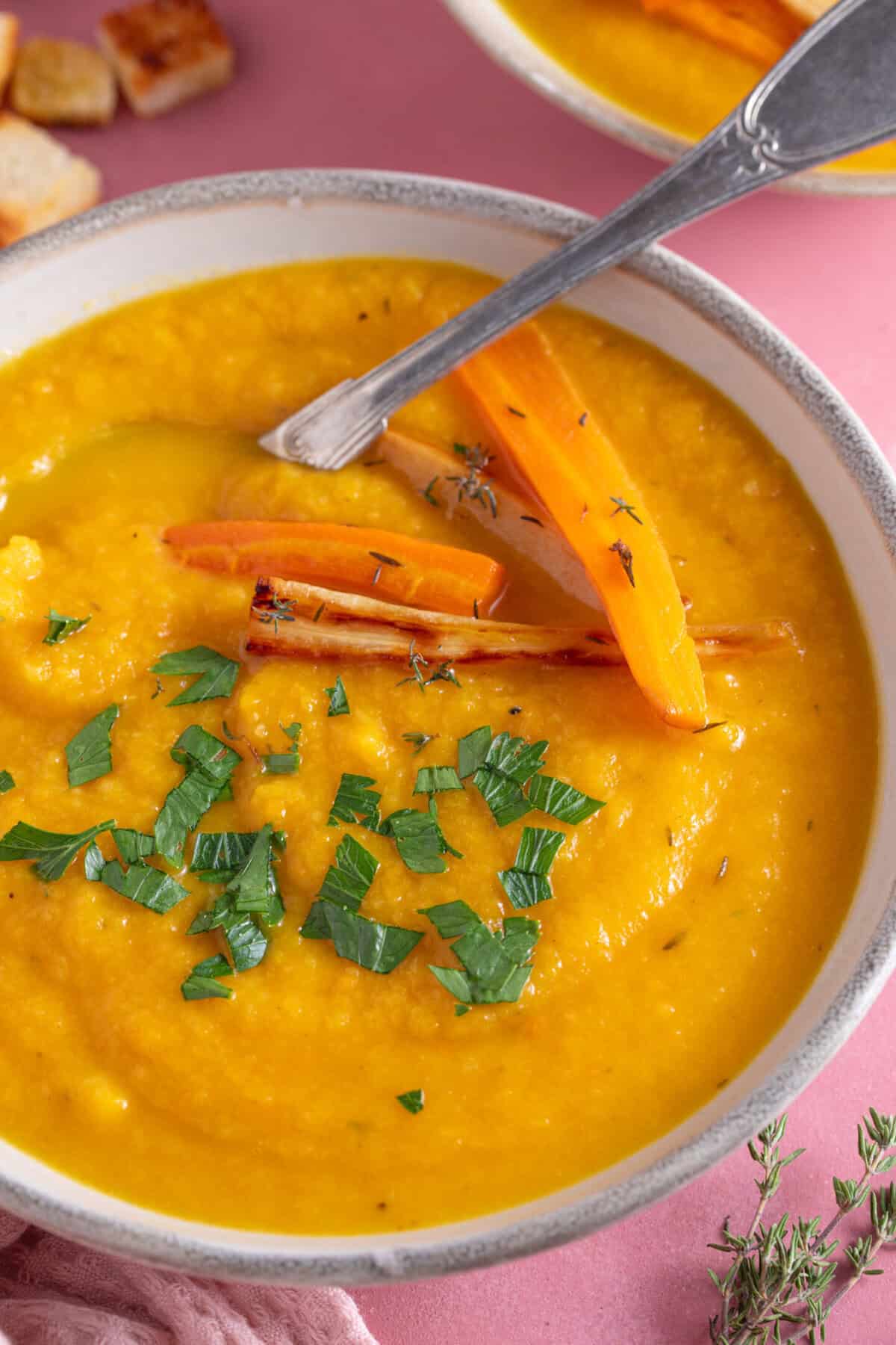 A bowl of roasted carrot and parsnip soup.