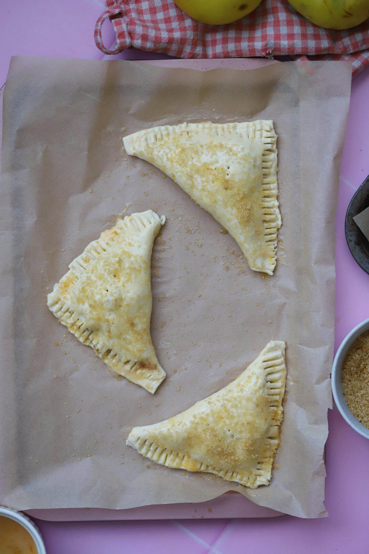 Fold the pastry diagonally over the filling, brush with egg and sprinkle with sugar before baking.