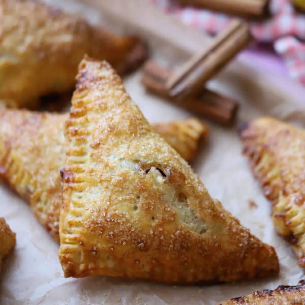 A tray full of gluten free apple turnovers.