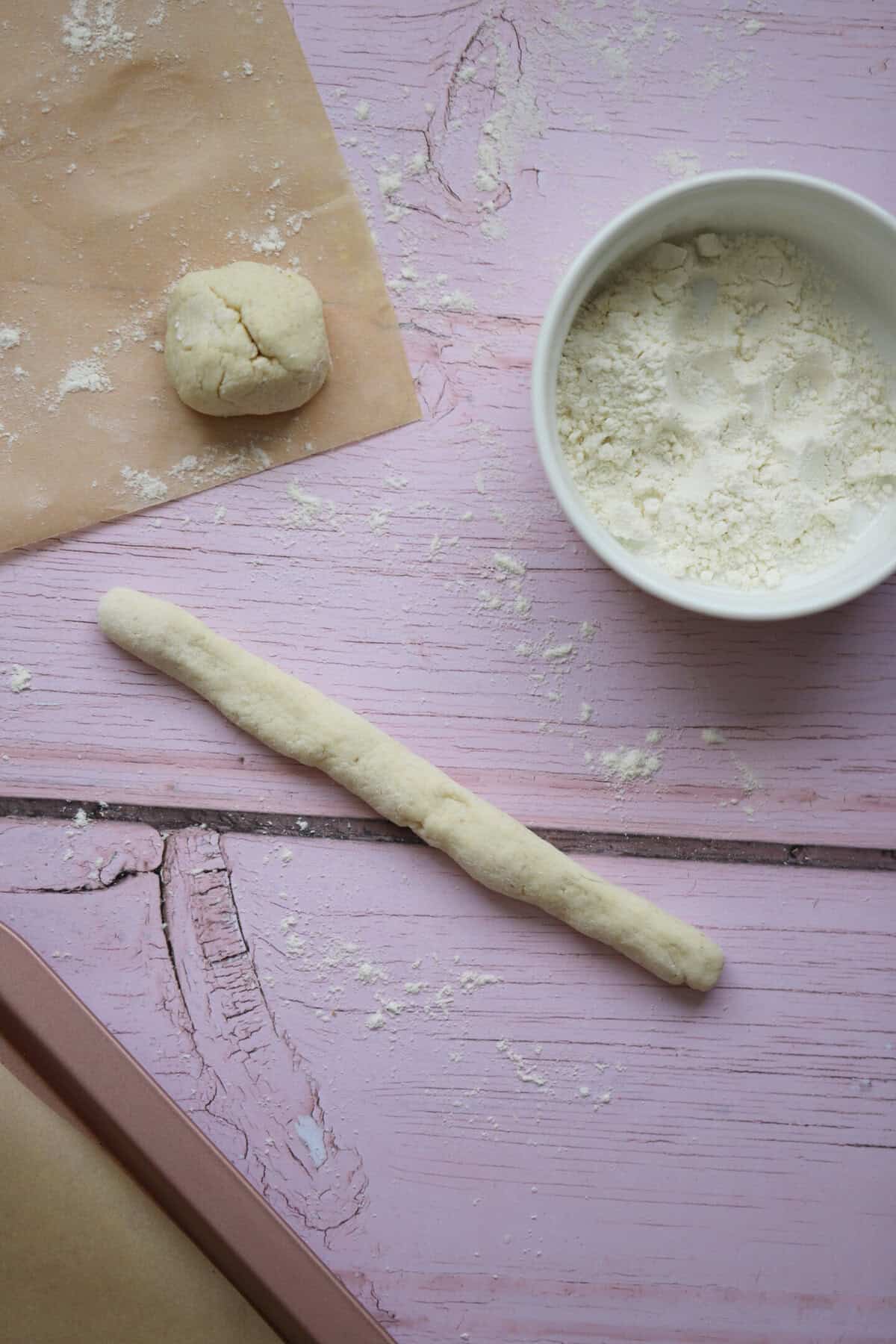 Roll the balls of dough into breadsticks.