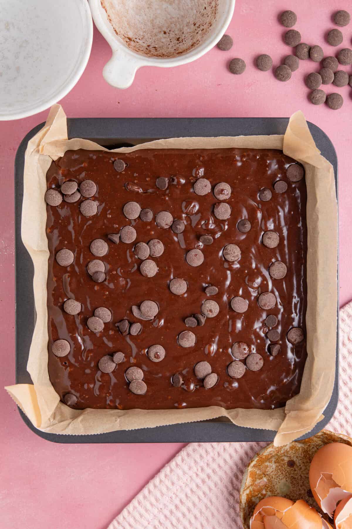 Pour the brownie batter into the pan and top with extra chocolate chips.
