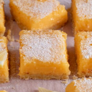 Gluten free lemon bars on a sheet of baking paper.