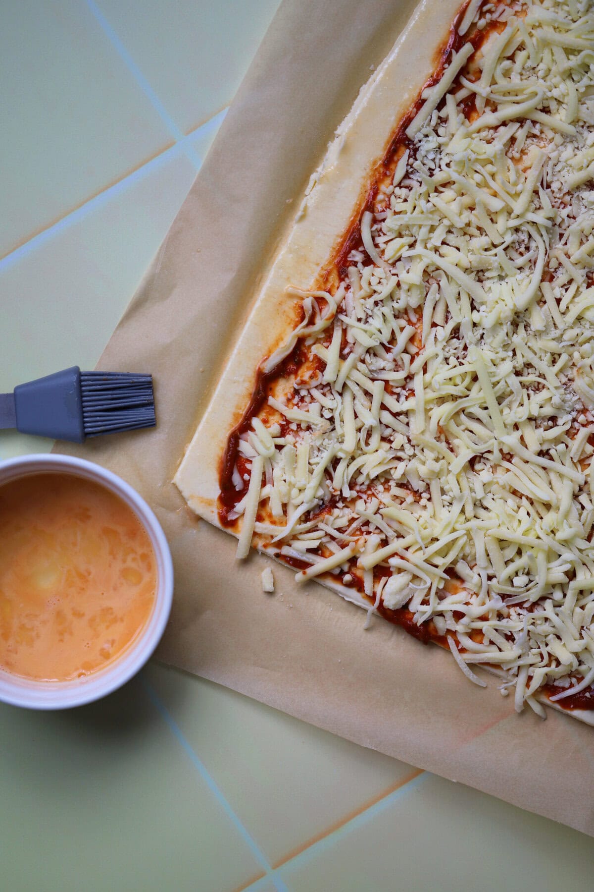 Brush one of the long edges of the pastry with the beaten egg.