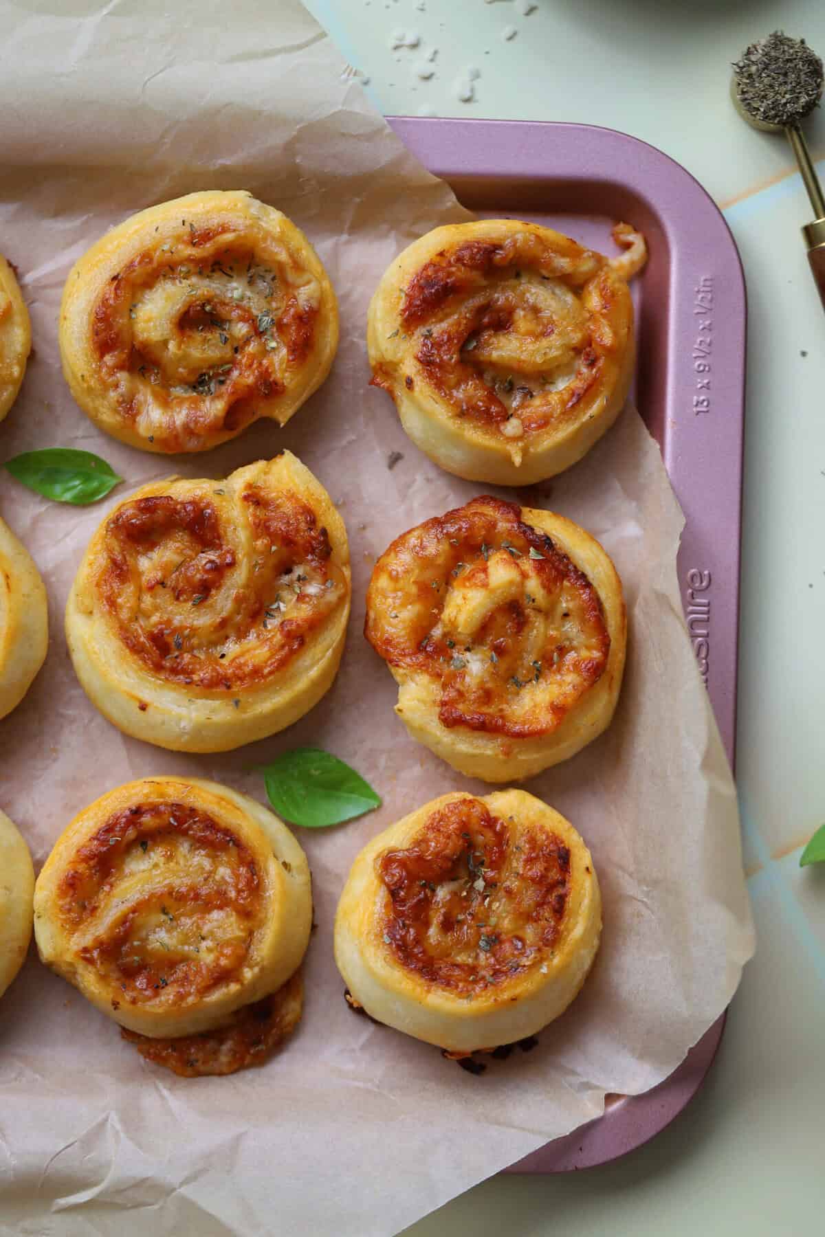 A tray of gluten free puff pastry pizza pinwheels.