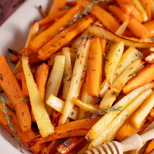 A large plate filled with roast carrots and parsnips.