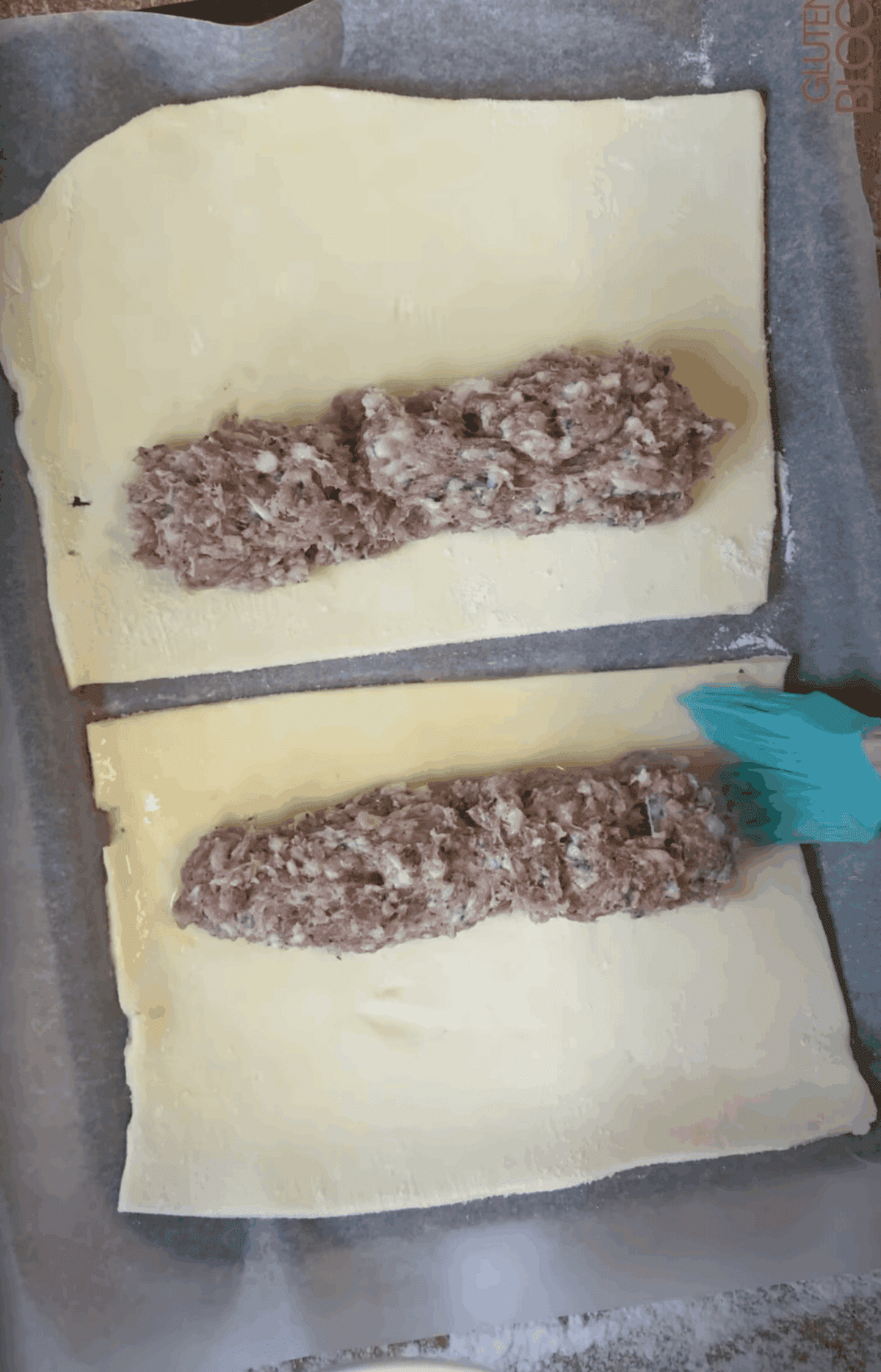 Split the sausage meat between the pastry sheets, leaving a border.