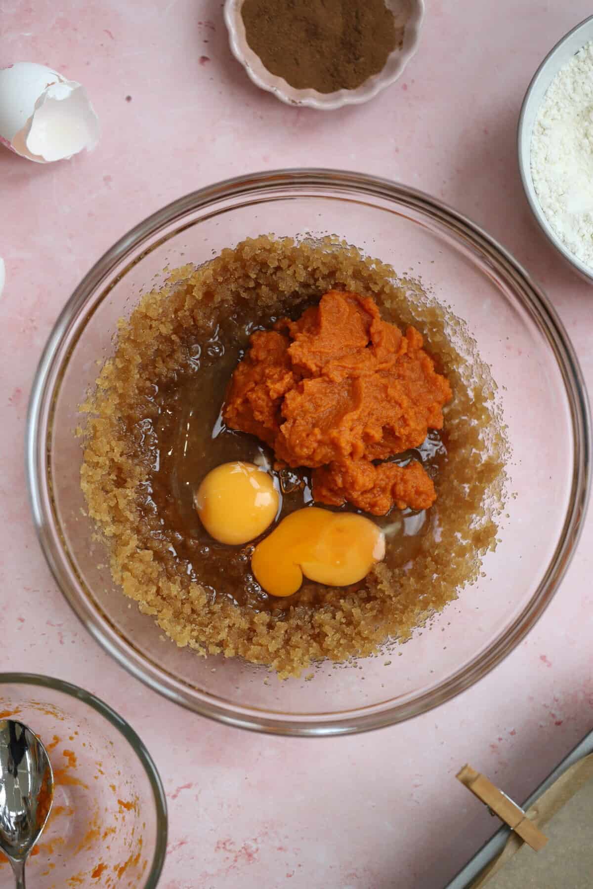 Add the eggs and pumpkin puree to the sugar and oil.