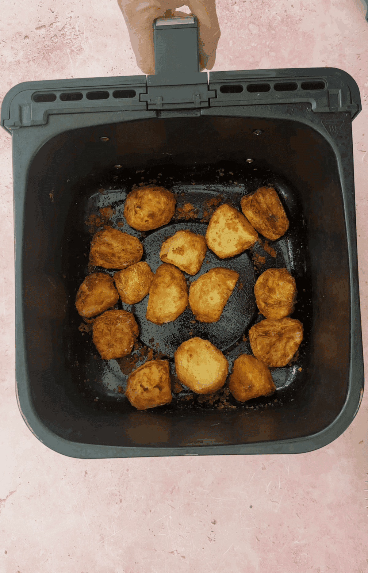Air fry the potatoes until crispy and golden.