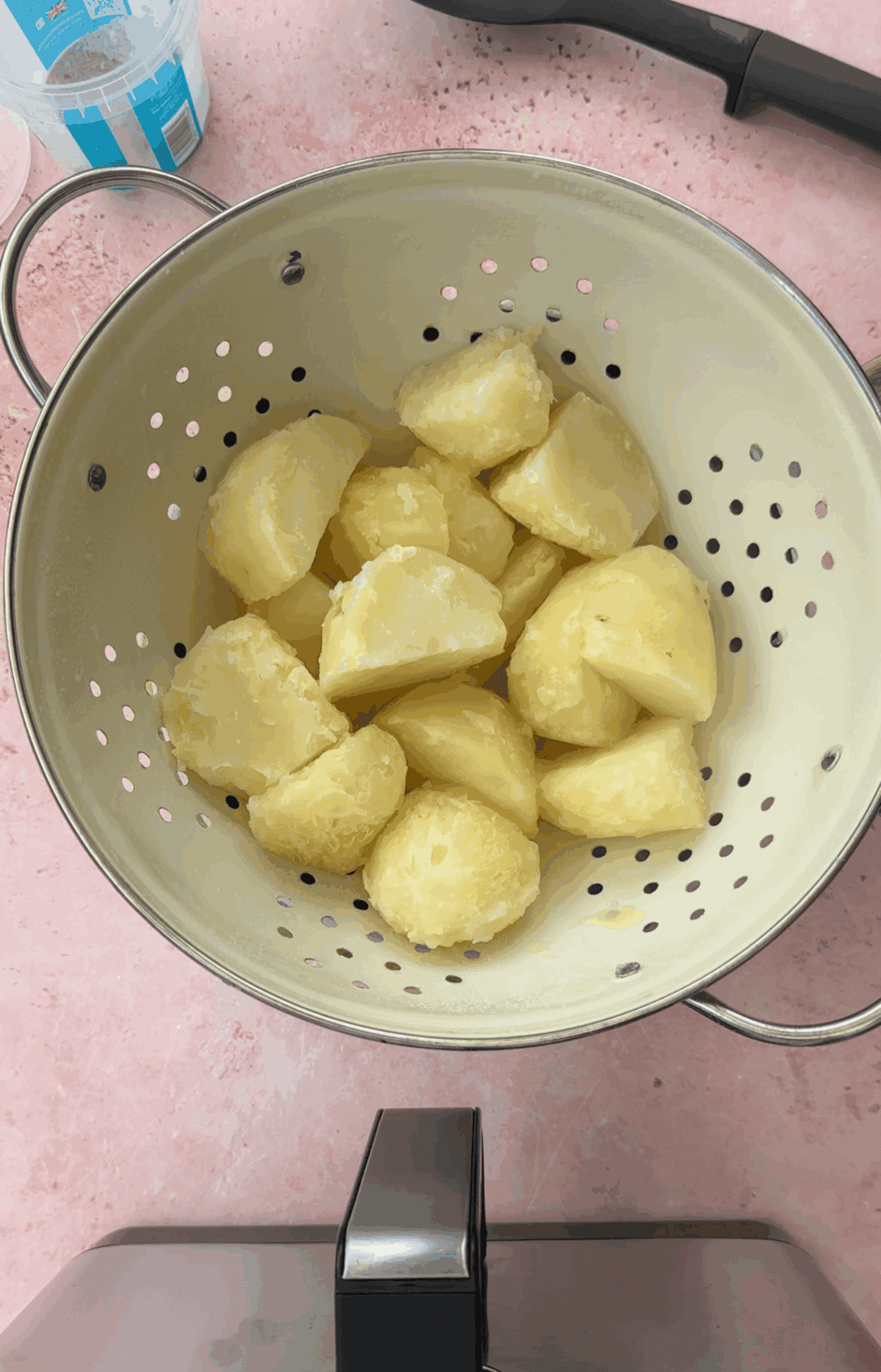 Drain the potatoes then rough them up in the colander.