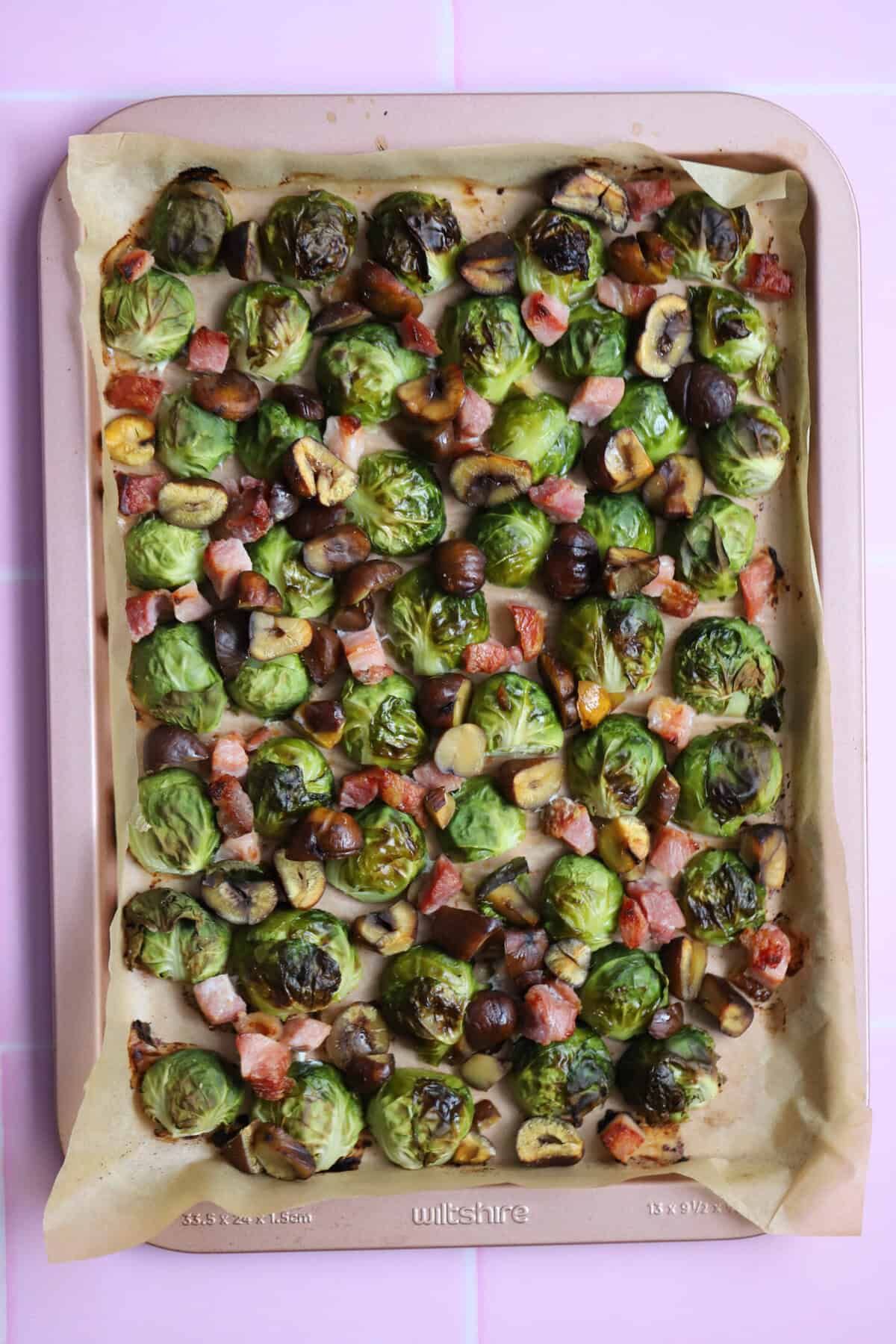 A tray of roasted sprouts, bacon and chestnuts.