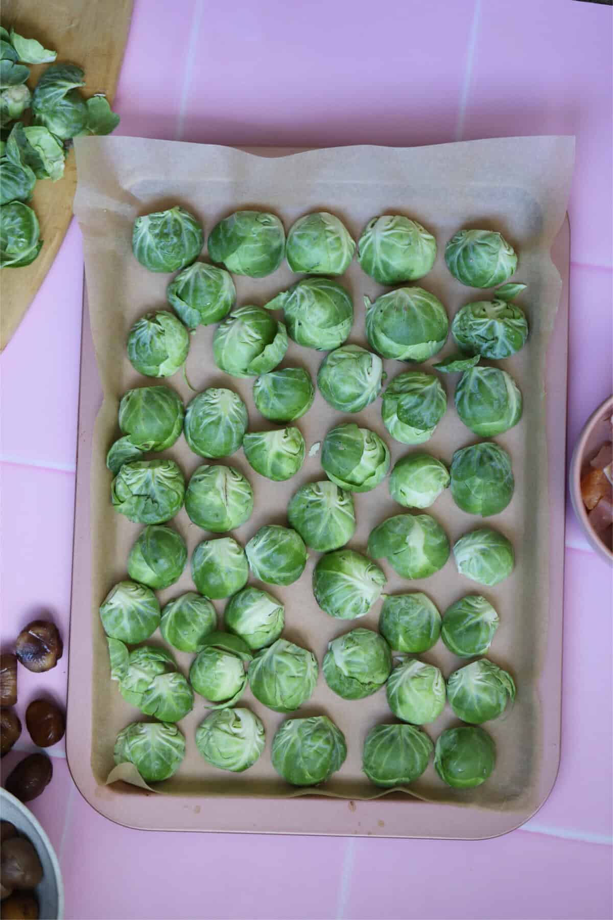 Cut the sprouts in half and lay them, cut-side-down, on a lined baking tray.
