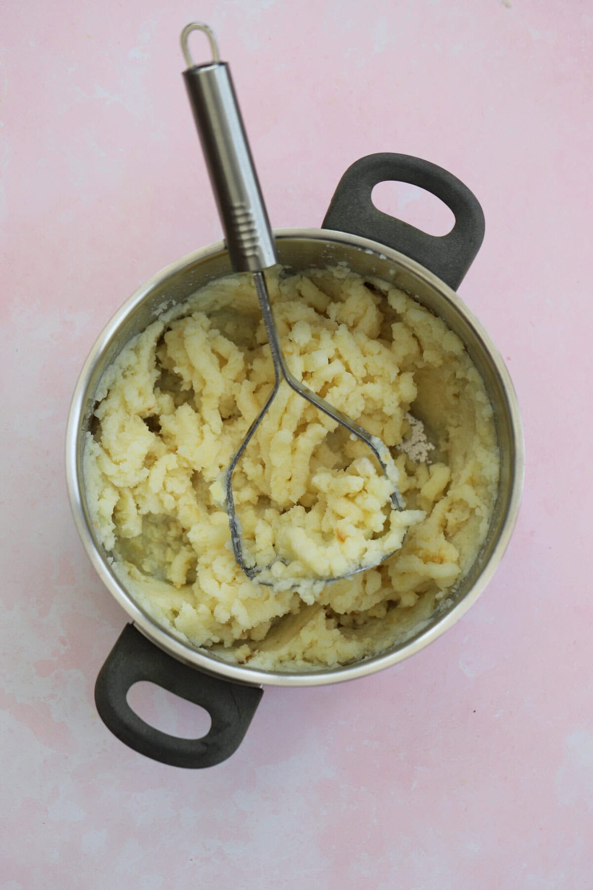 Mash the potatoes until they are as fine as possible.