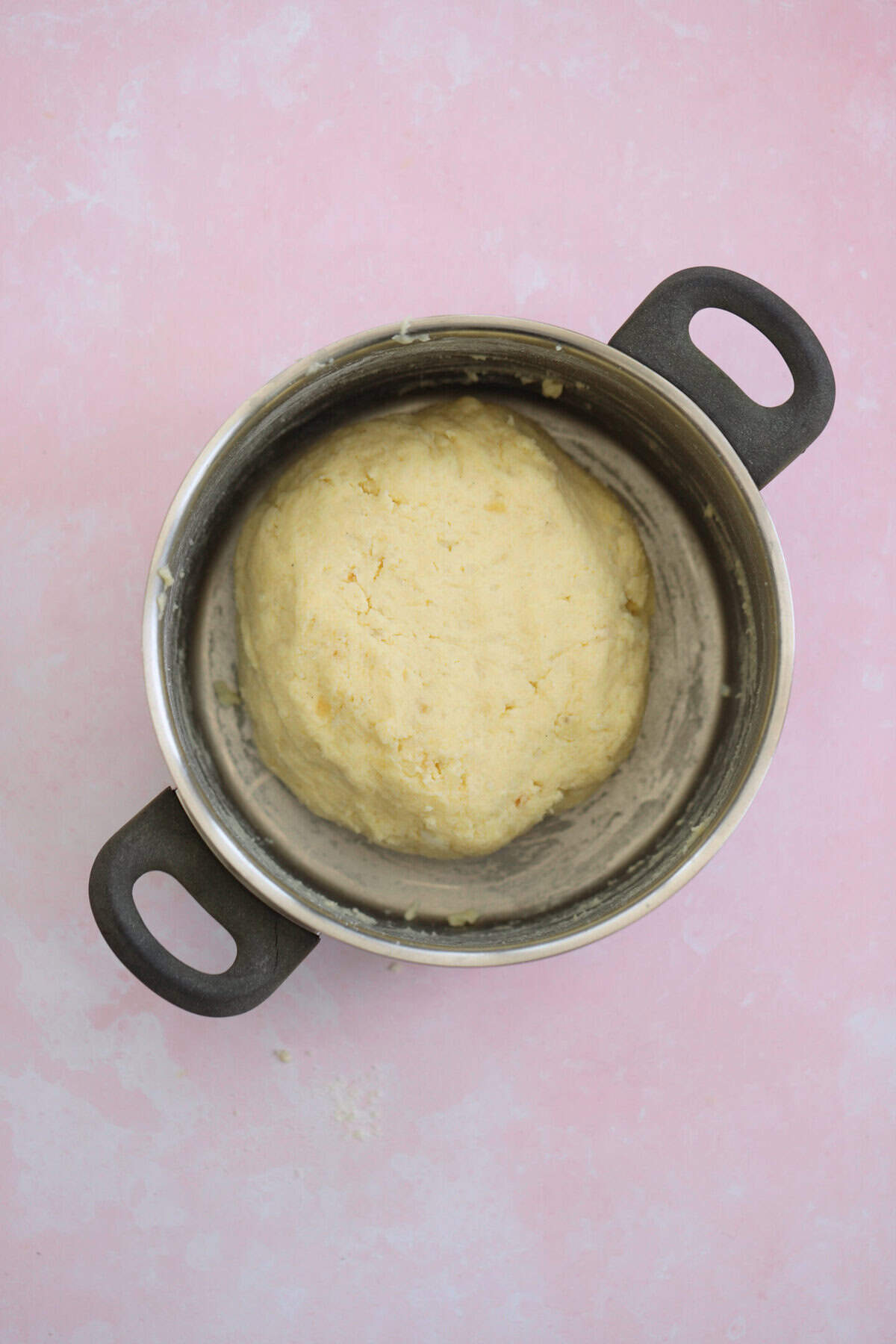 Keep mixing the dough together, using a spoon then your hand, until it forms a smooth ball.