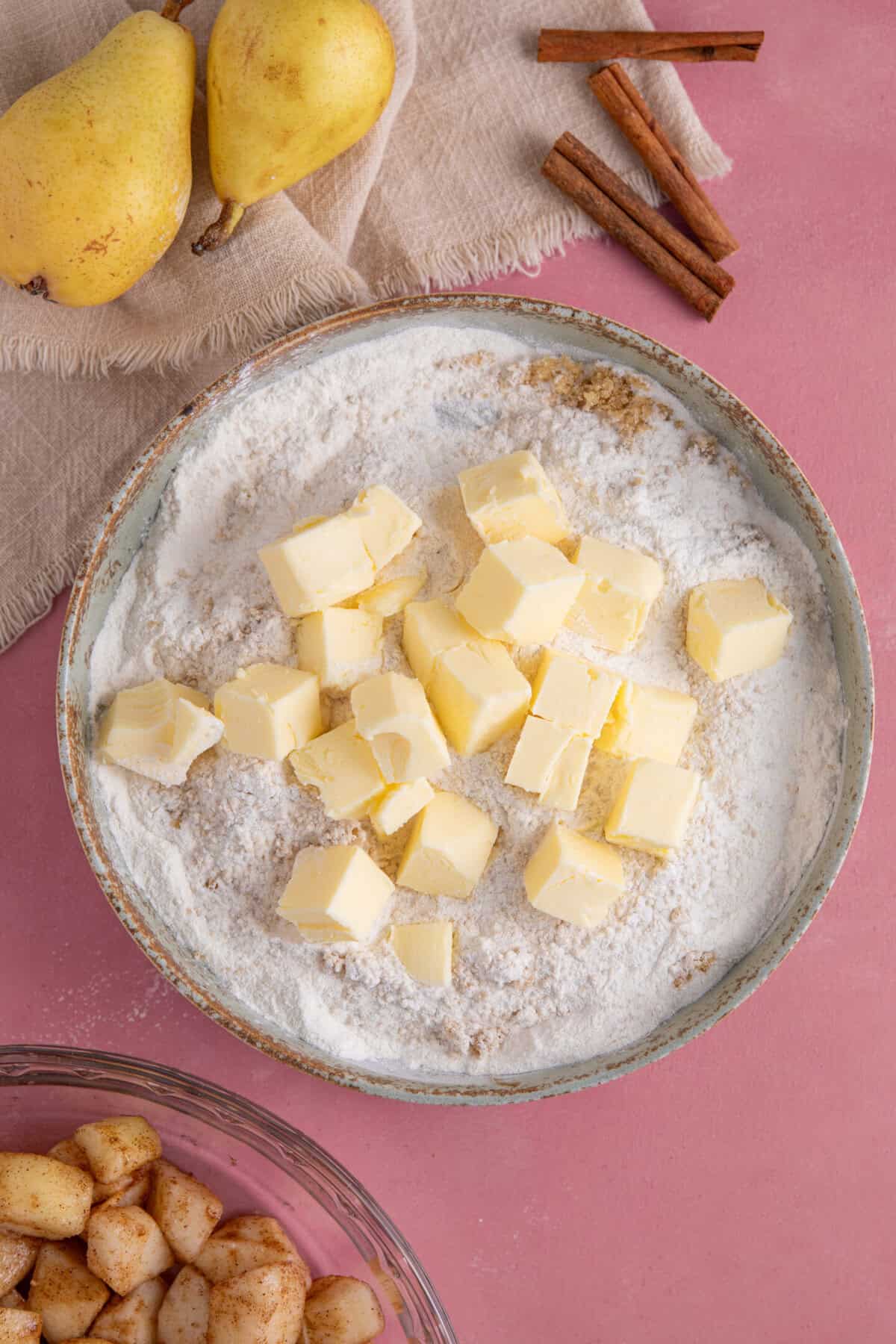 Add the cubes of cold butter into the gluten free flour and sugar.