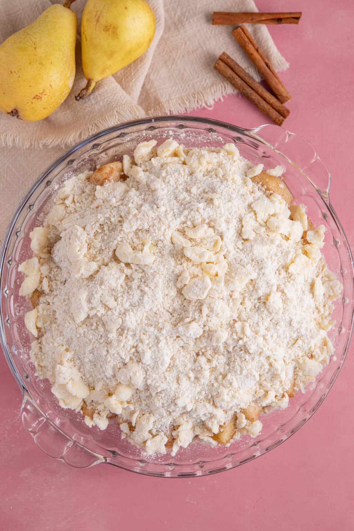 Top the pear filling with crumble top and then bake until golden.