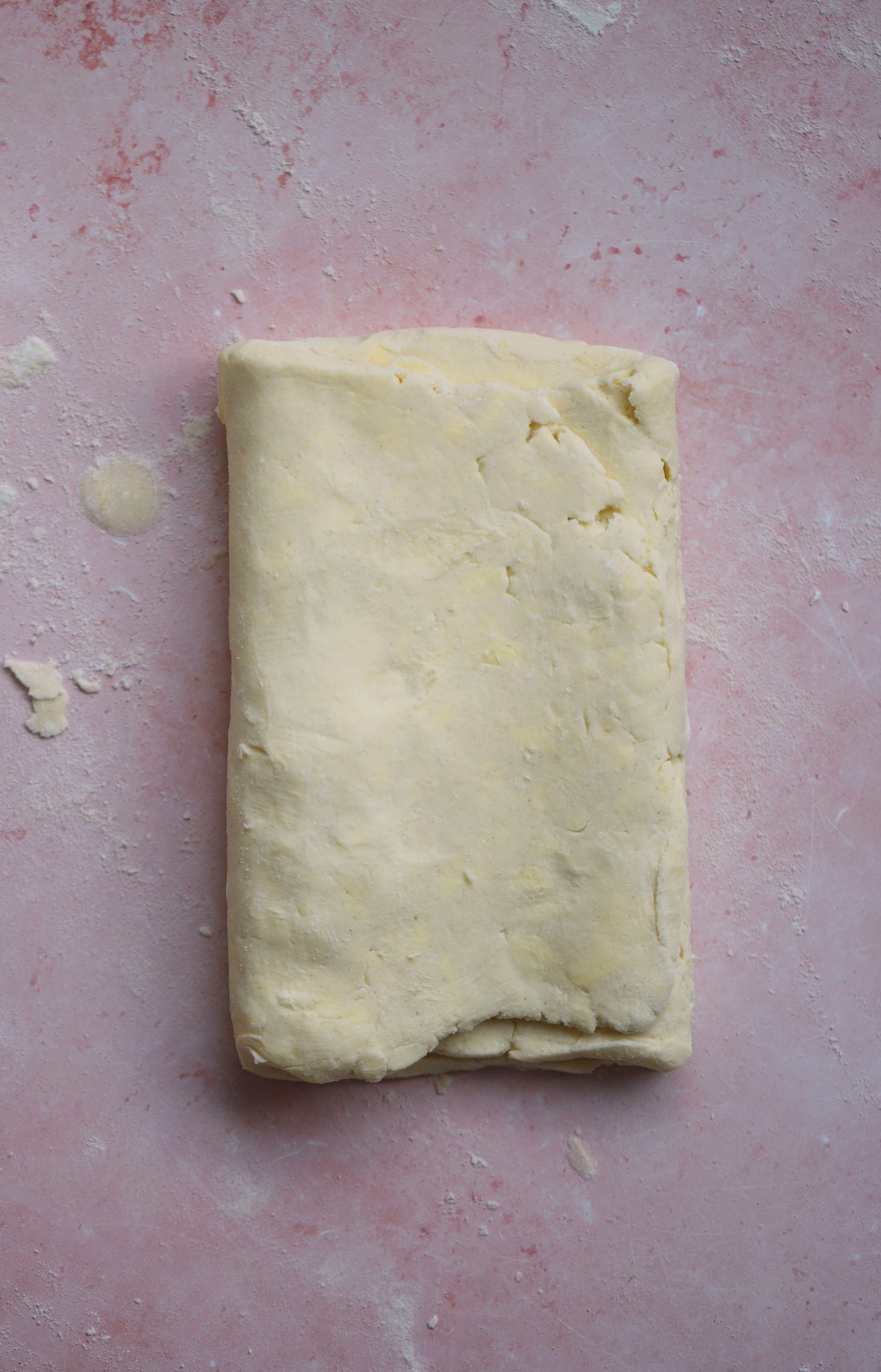 Fold the puff pastry dough a quarter turn clockwise before repeating.
