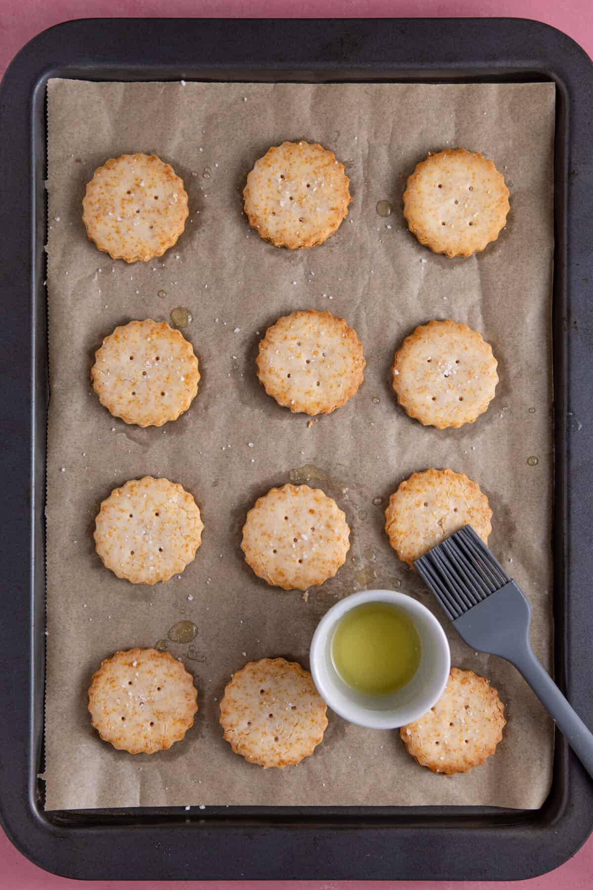 Brush the baked Ritz crackers with melted butter and sprinkle with sea salt.