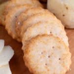 Gluten free Ritz Crackers on a wooden serving board.
