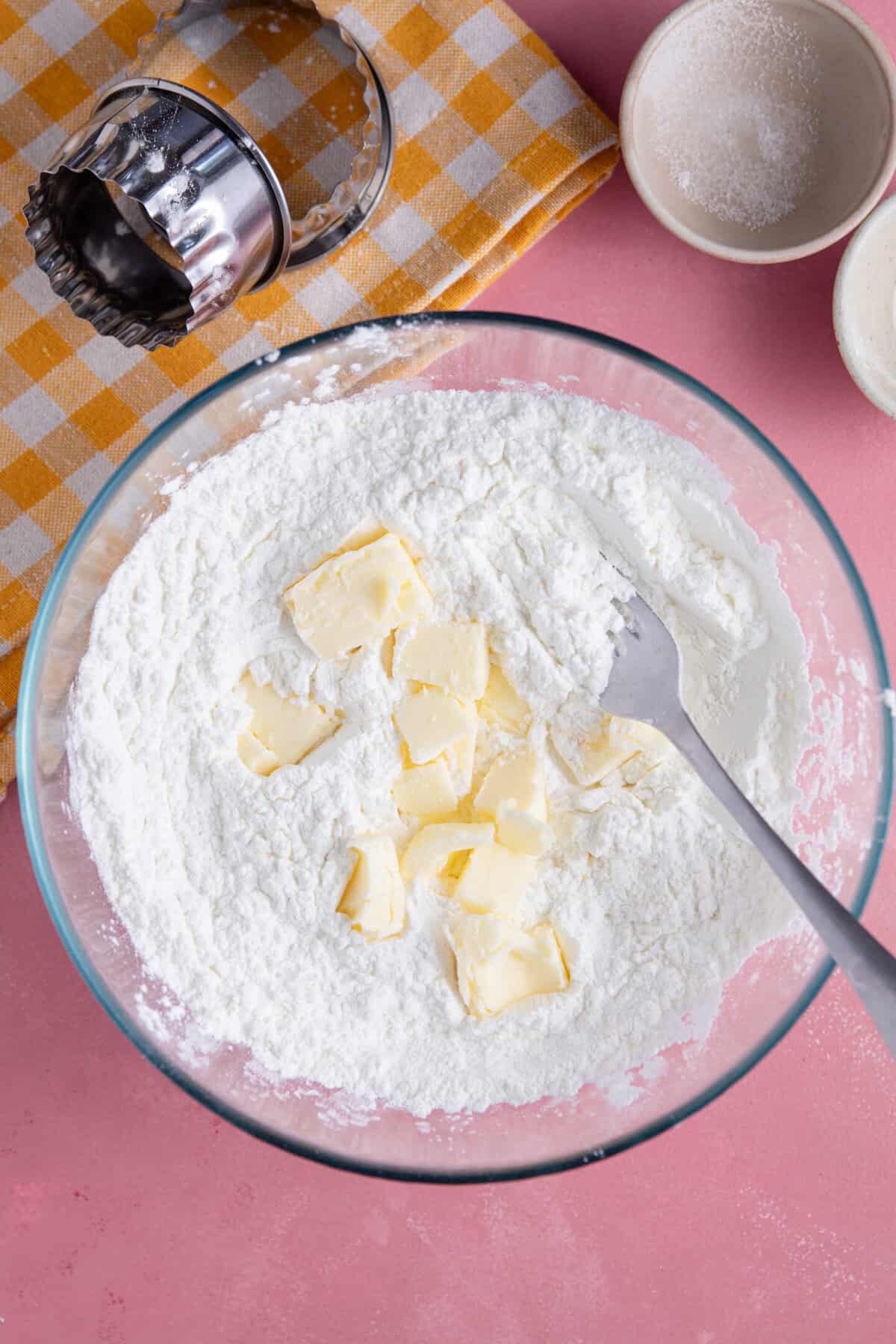 Add cubes of cold butter to the mixing bowl.