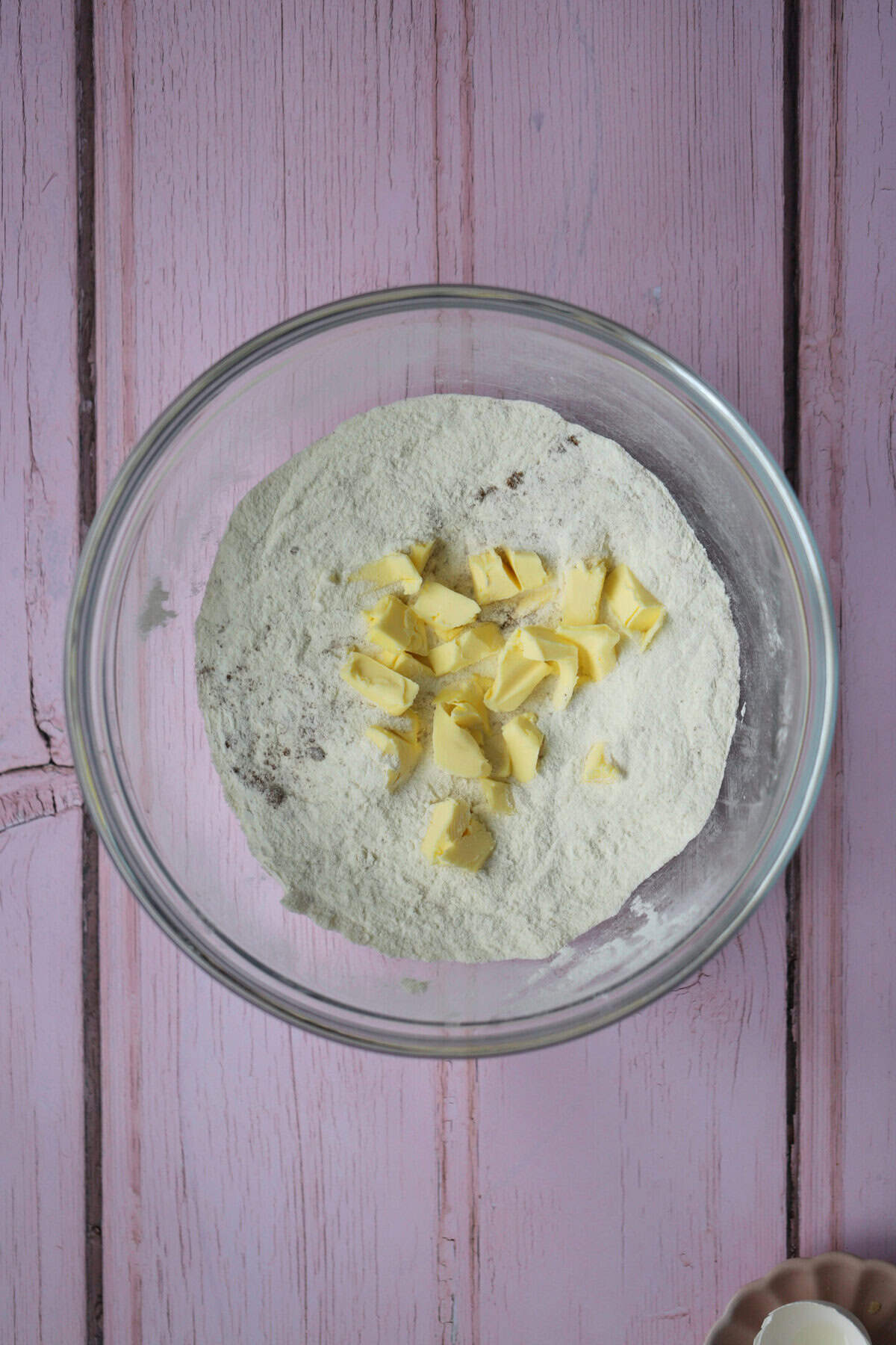 Add the cubed butter to the dry ingredients.