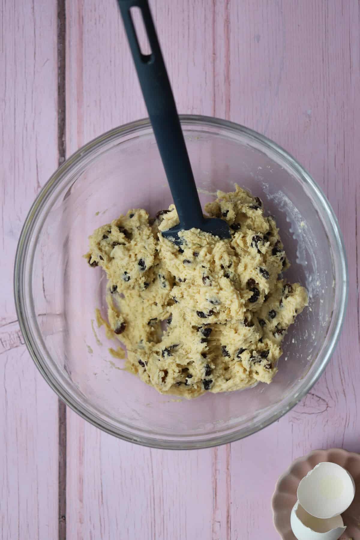 Add the milk, eggs and dried fruit to form a sticky dough.