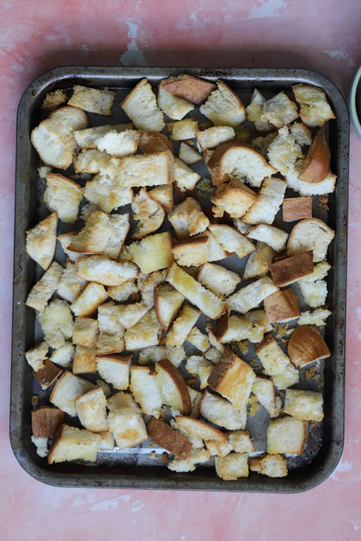 Tear or cut the gluten free bread into chunks then bake with some olive oil until toasted.