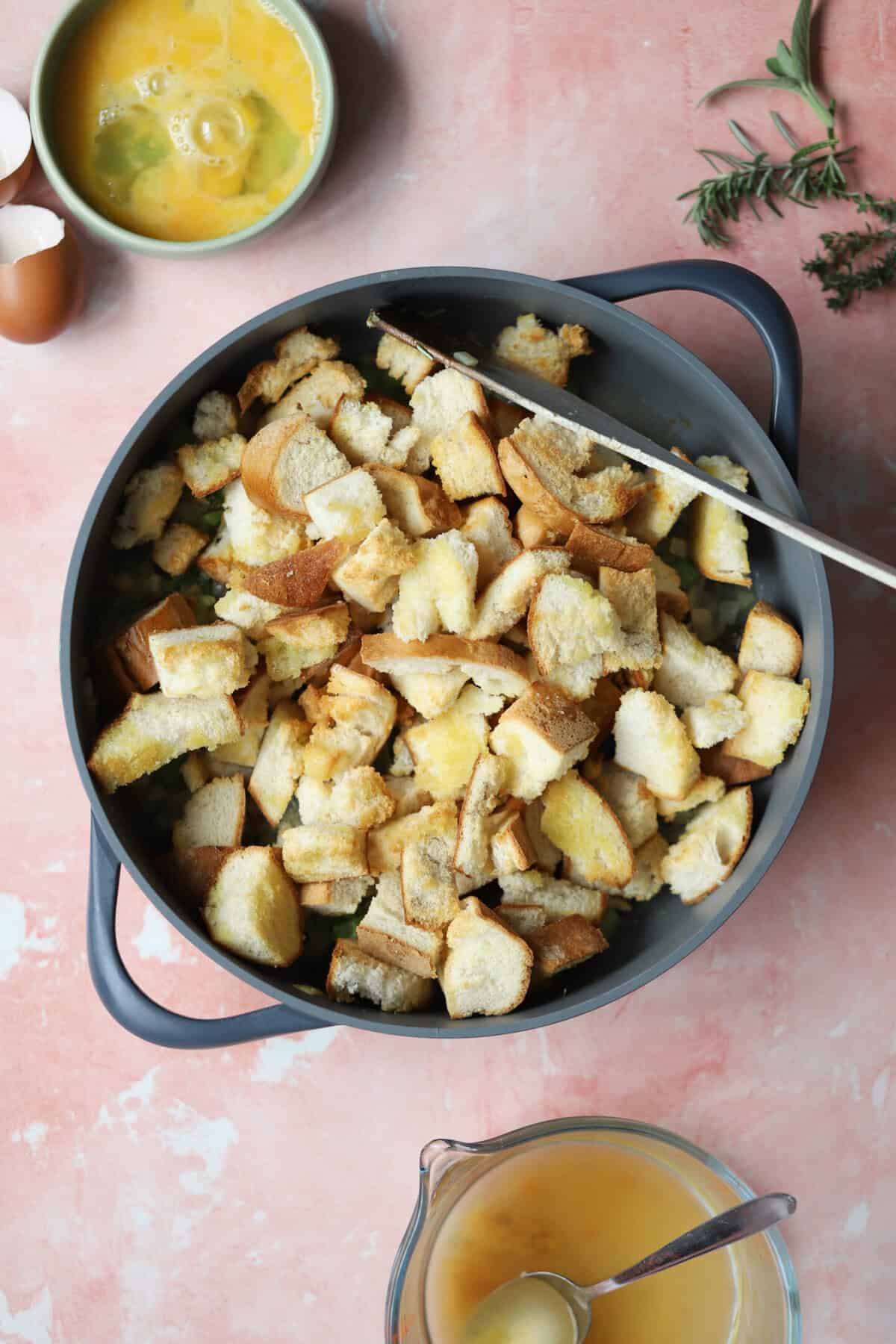 Add the toasted bread and half the stock to the pan and mix well.