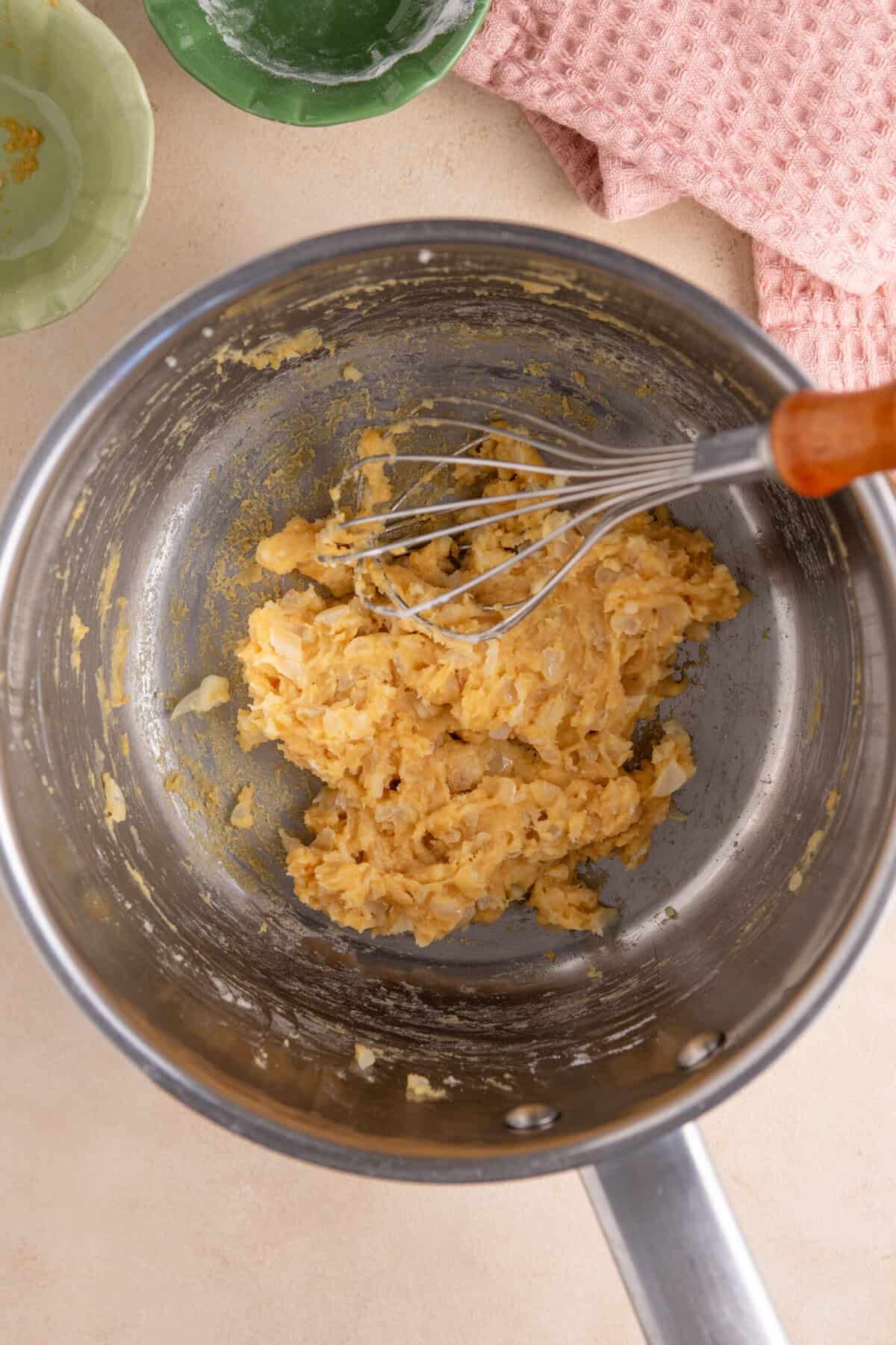 Add the flour and miso to the aromatics to form a paste.