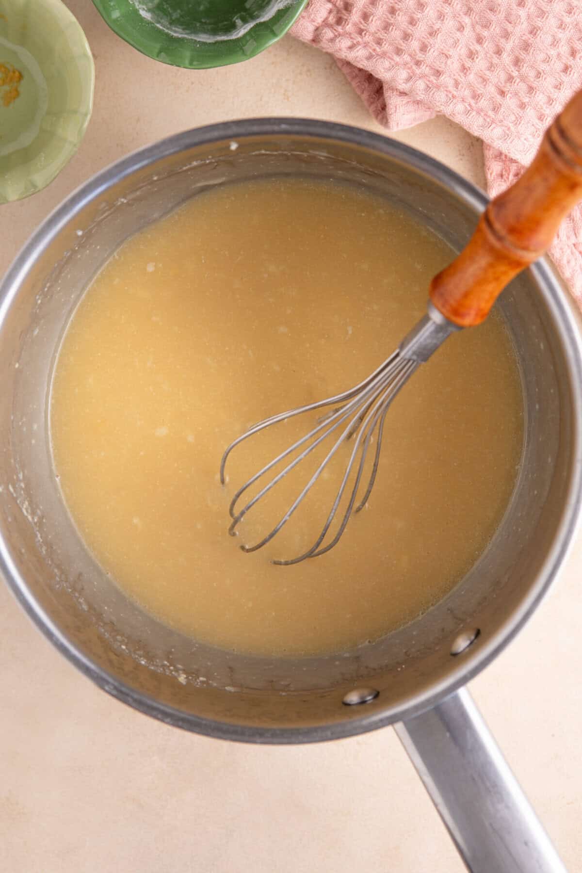 Gradually add the vegetable stock, whisking to ensure you don't have lumps.