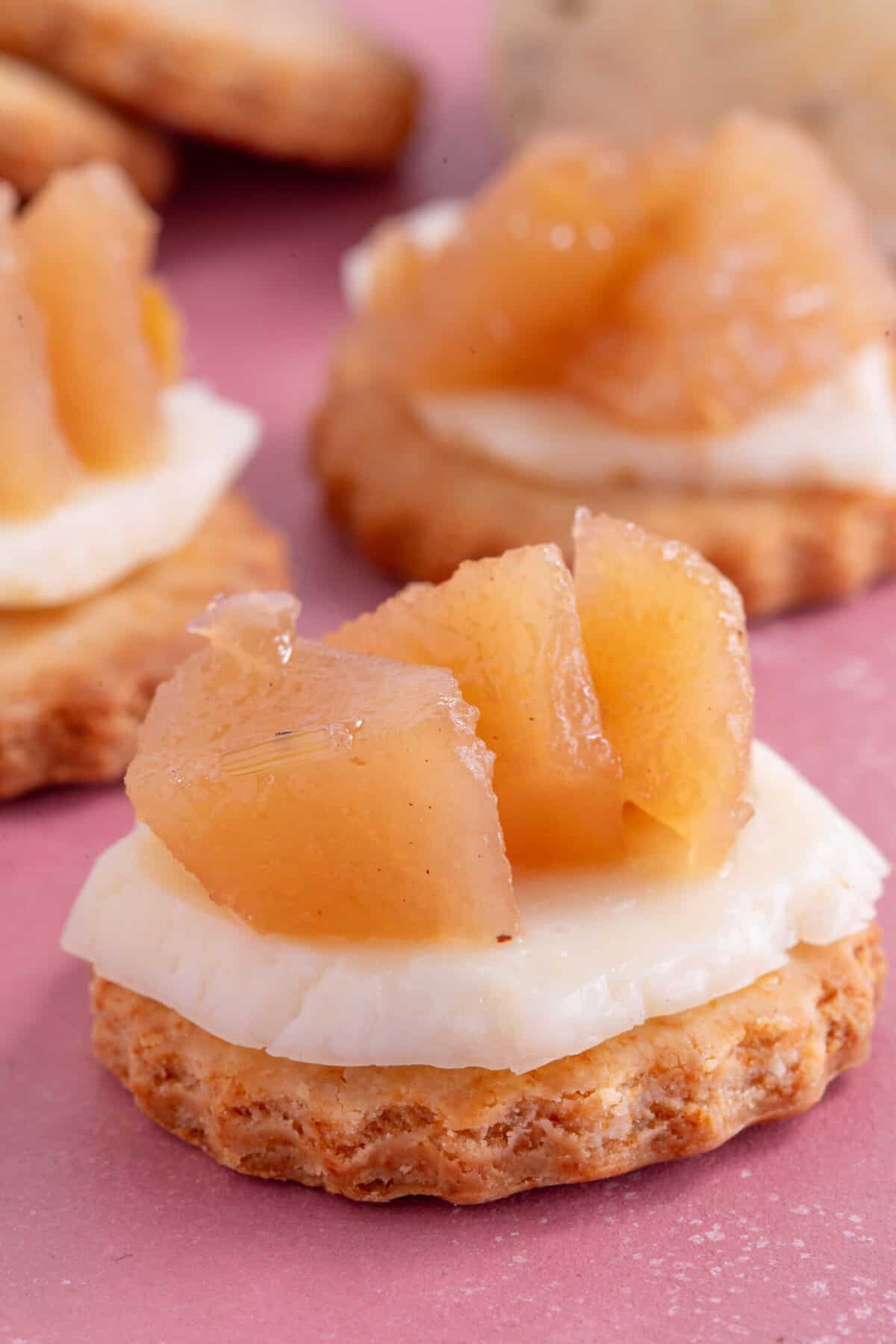 Close up of pear chutney on a cracker with cheese.