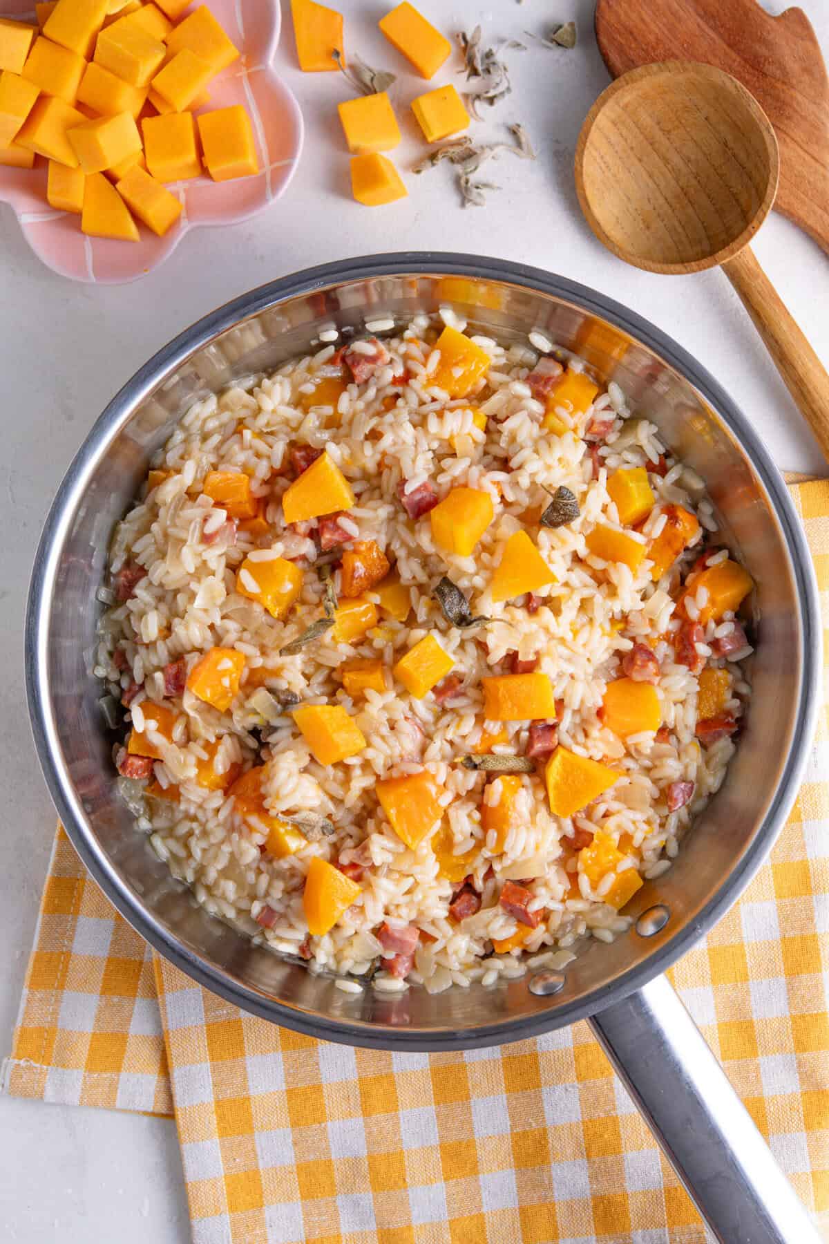 Roasted butternut squash risotto in a pan.