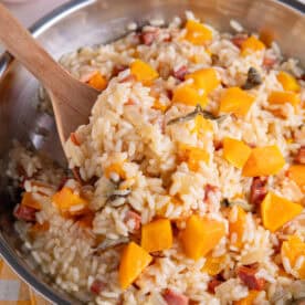A large pan of butternut squash and chorizo risotto with sage and parmesan.