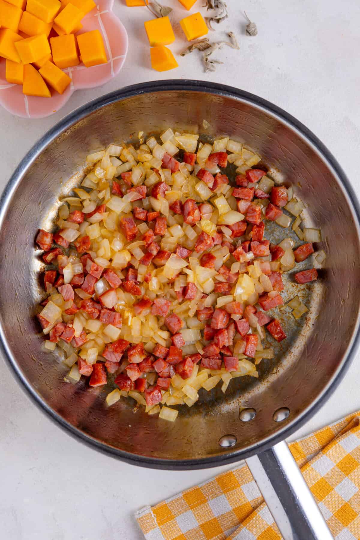 Fry the onions and chorizo in the olive oil.