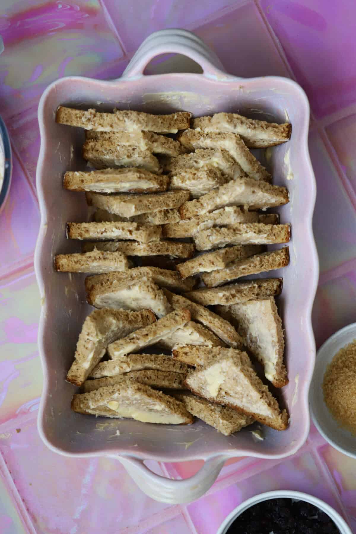 Arrange the buttered bread triangles in a large dish - it doesn't have to be too perfect!