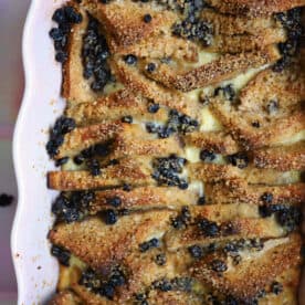 Gluten free bread and butter pudding in a pink dish.