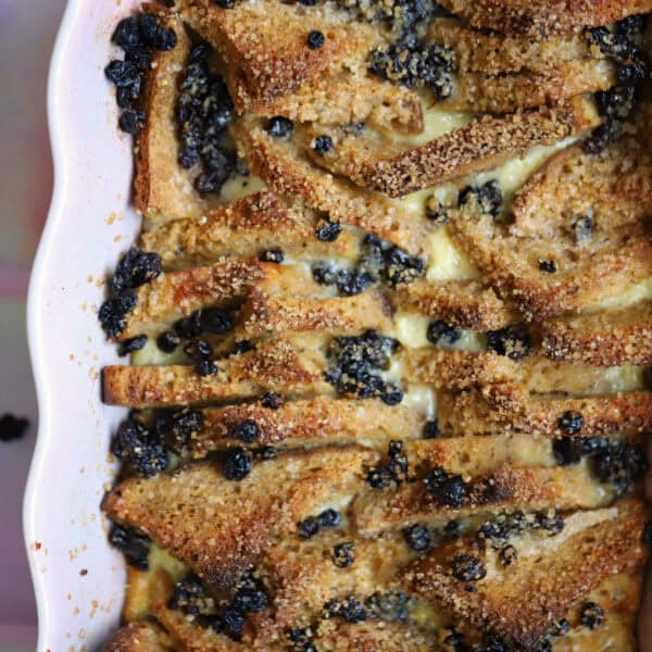 Gluten free bread and butter pudding in a pink dish.