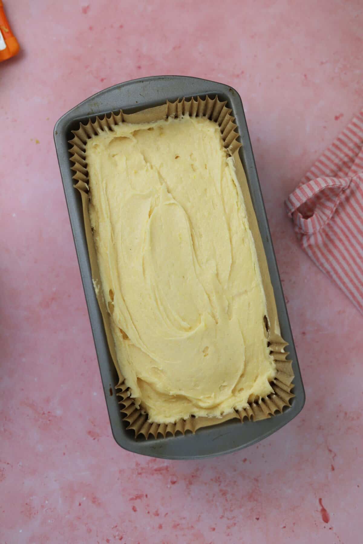 Pour the cake batter into a lined loaf tin and smooth the top.