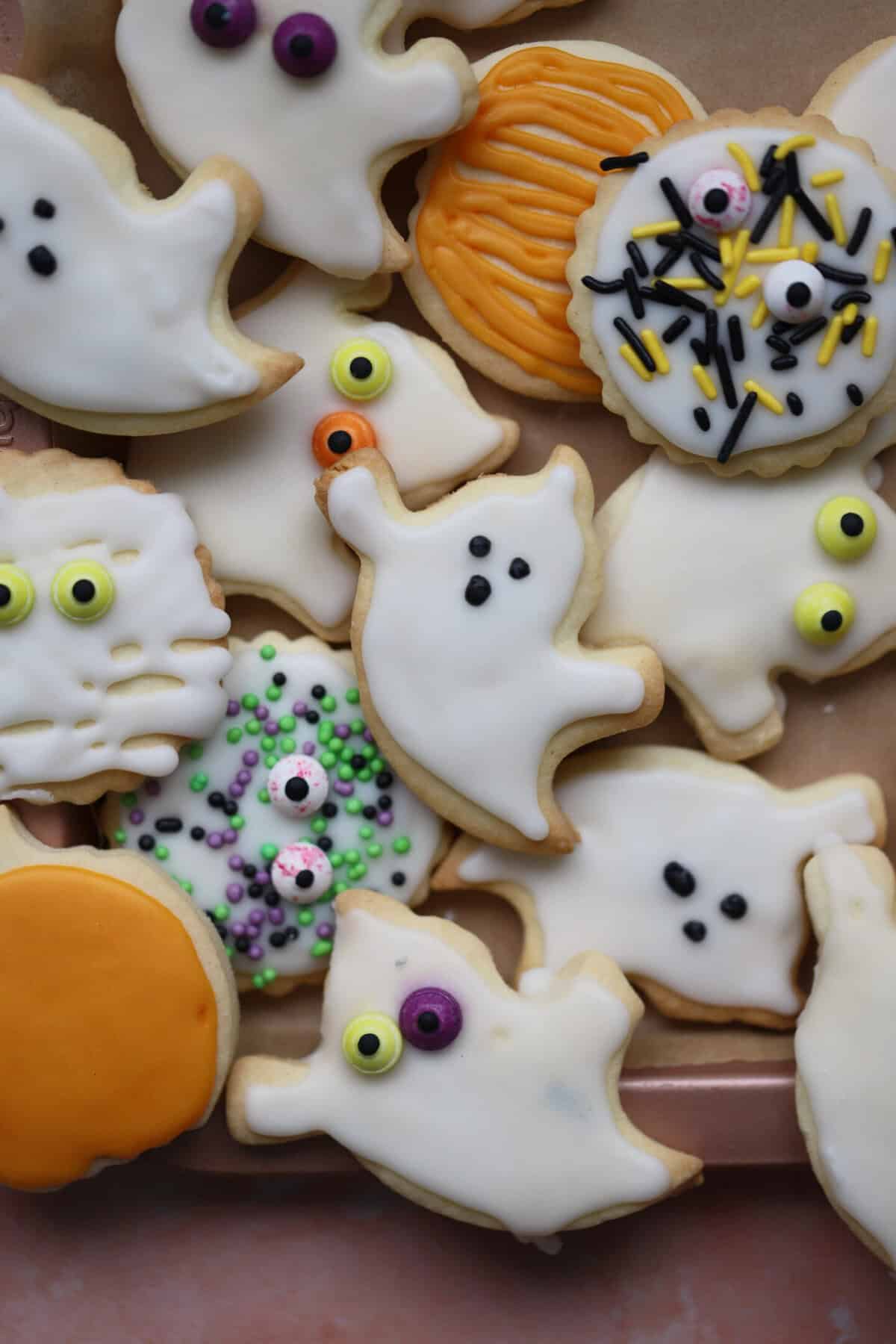 A tray of Halloween biscuits shaped like ghosts, ghouls and pumpkins.