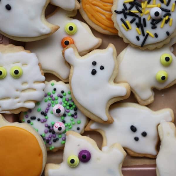 A tray of Halloween biscuits shaped like ghosts, ghouls and pumpkins.