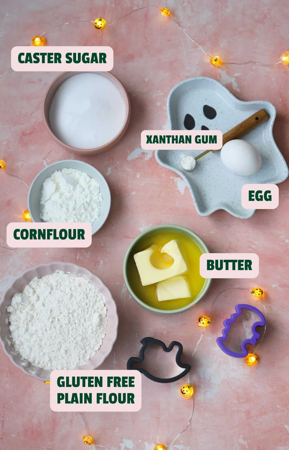 Ingredients for gluten free Halloween biscuits with text labels.