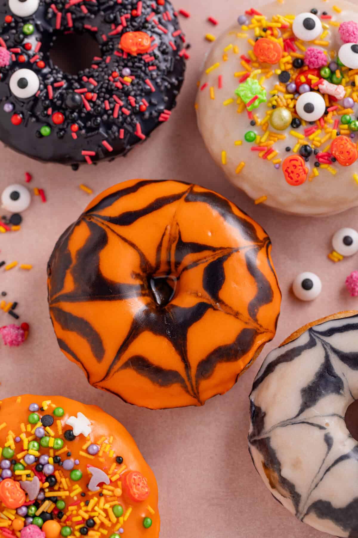 Gluten free baked doughnuts with halloween icing and sprinkles.