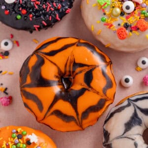 Gluten free baked doughnuts with halloween icing and sprinkles.