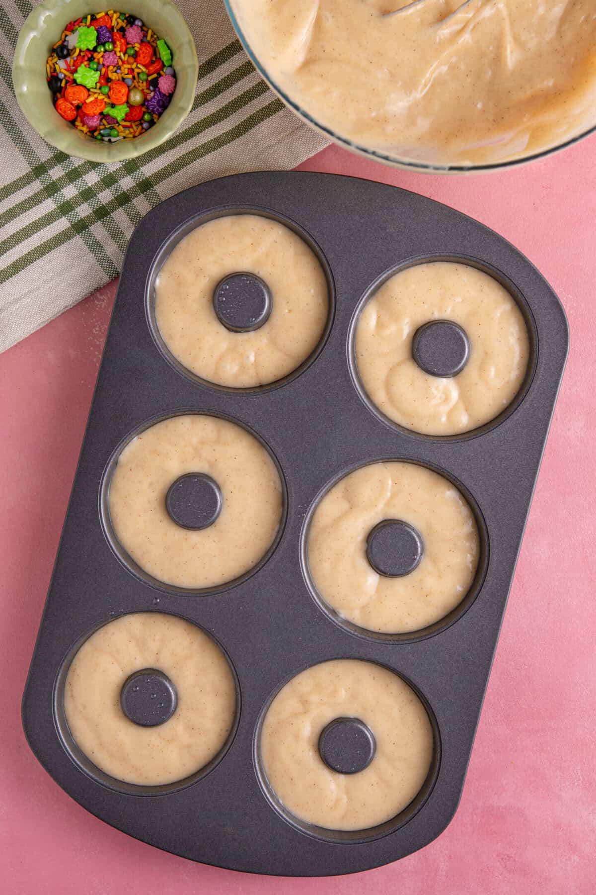 Pour the batter into the doughnut pan and bake until golden.