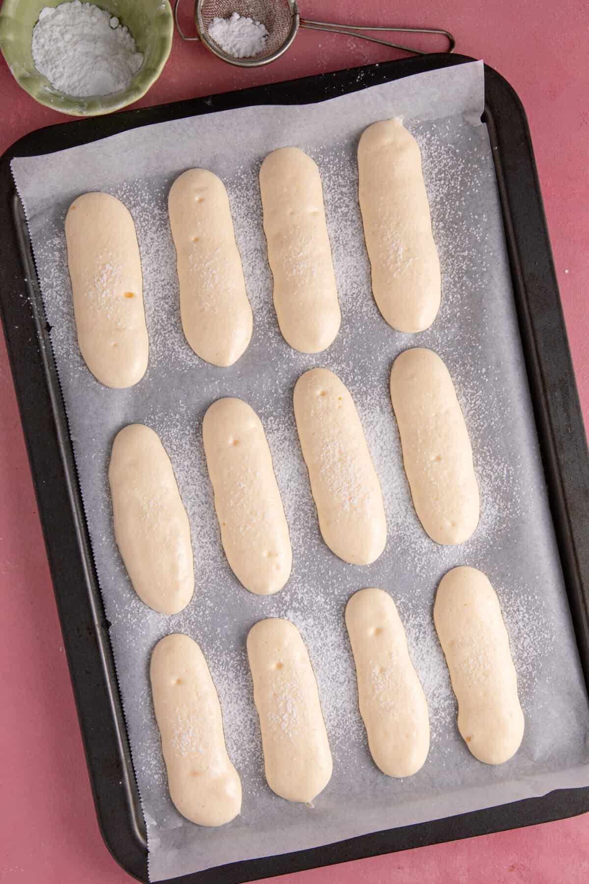 Pipe the lady fingers onto a baking sheet with a little space between them.